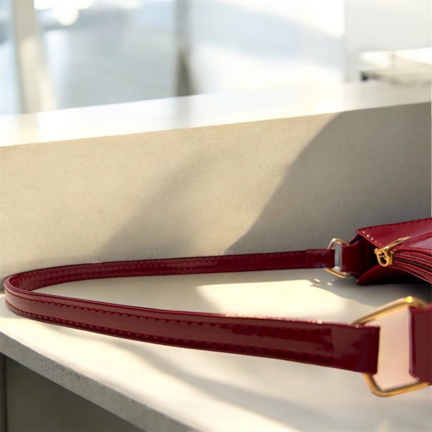 Maroon Patent leather bag close-up strap